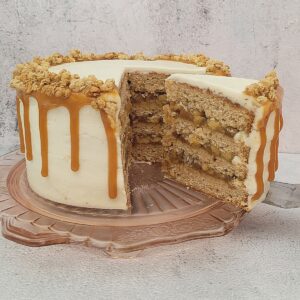 spice cake with apple filling and one slice being removed from cake