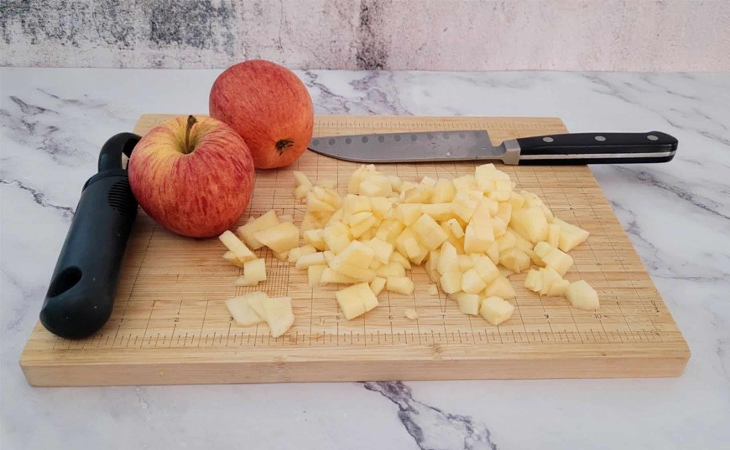 chopped and whole apples on a cutting board