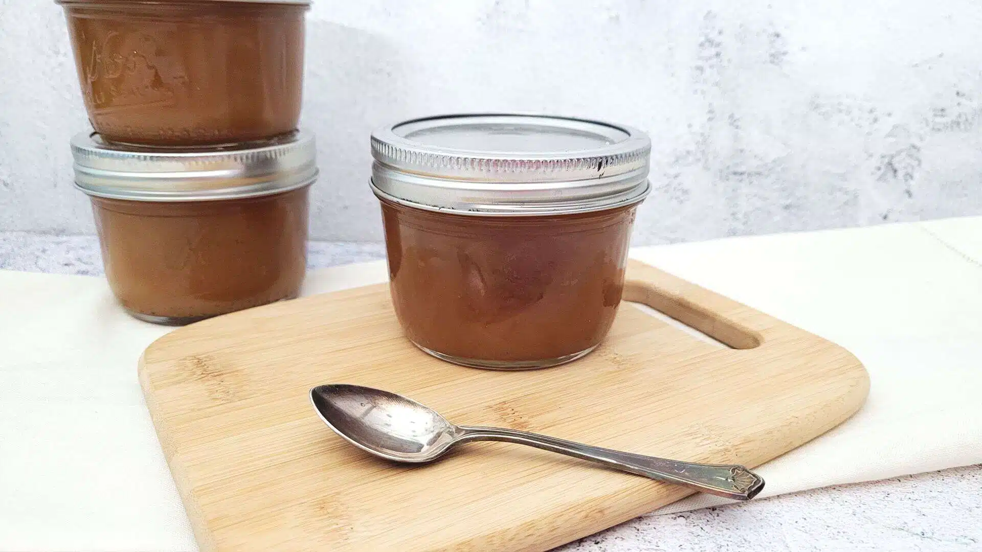 jar of caramel sauce on a wooden board