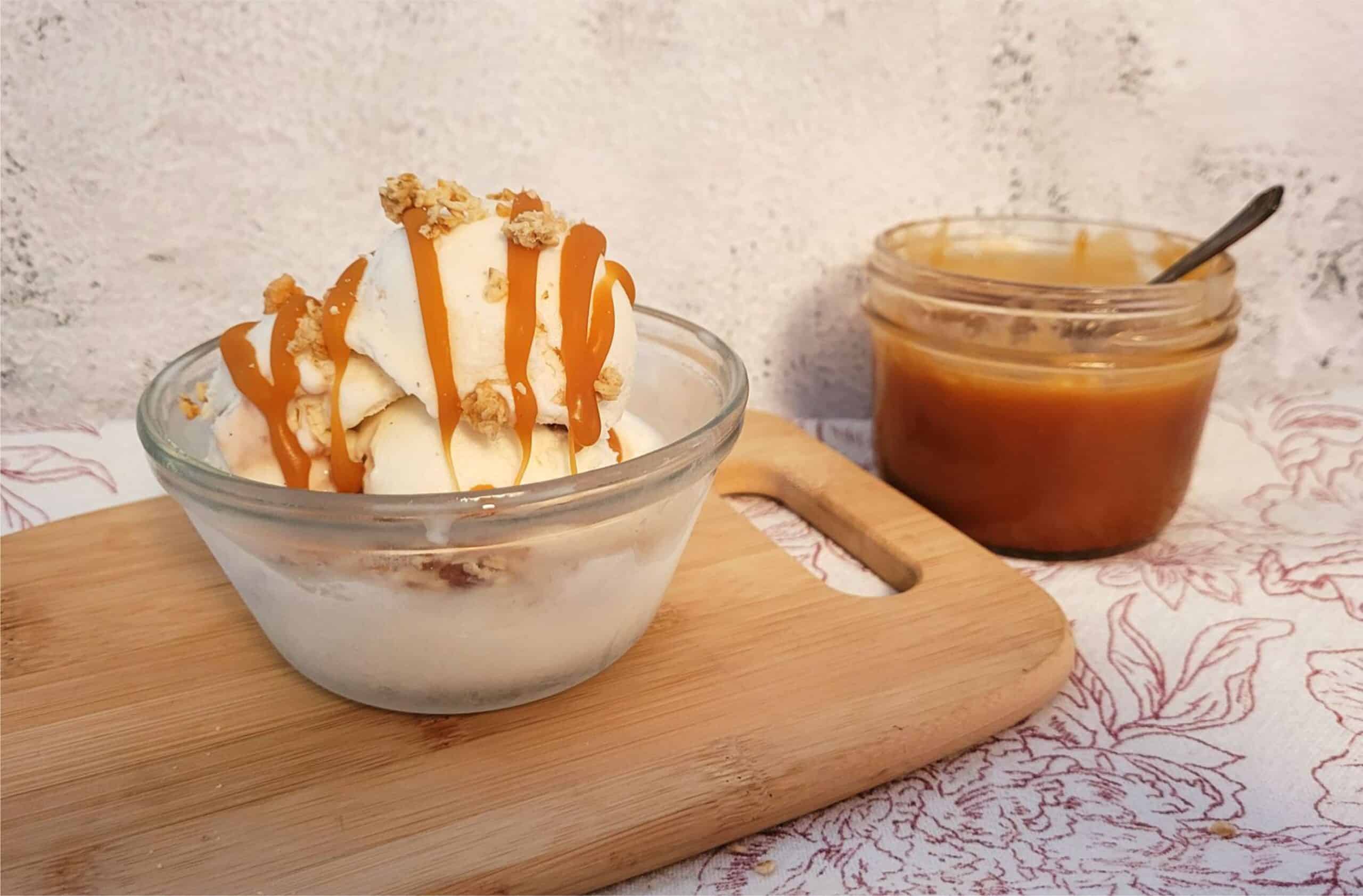 bowl of vanilla ice cream with homemade caramel sauce drizzled over it