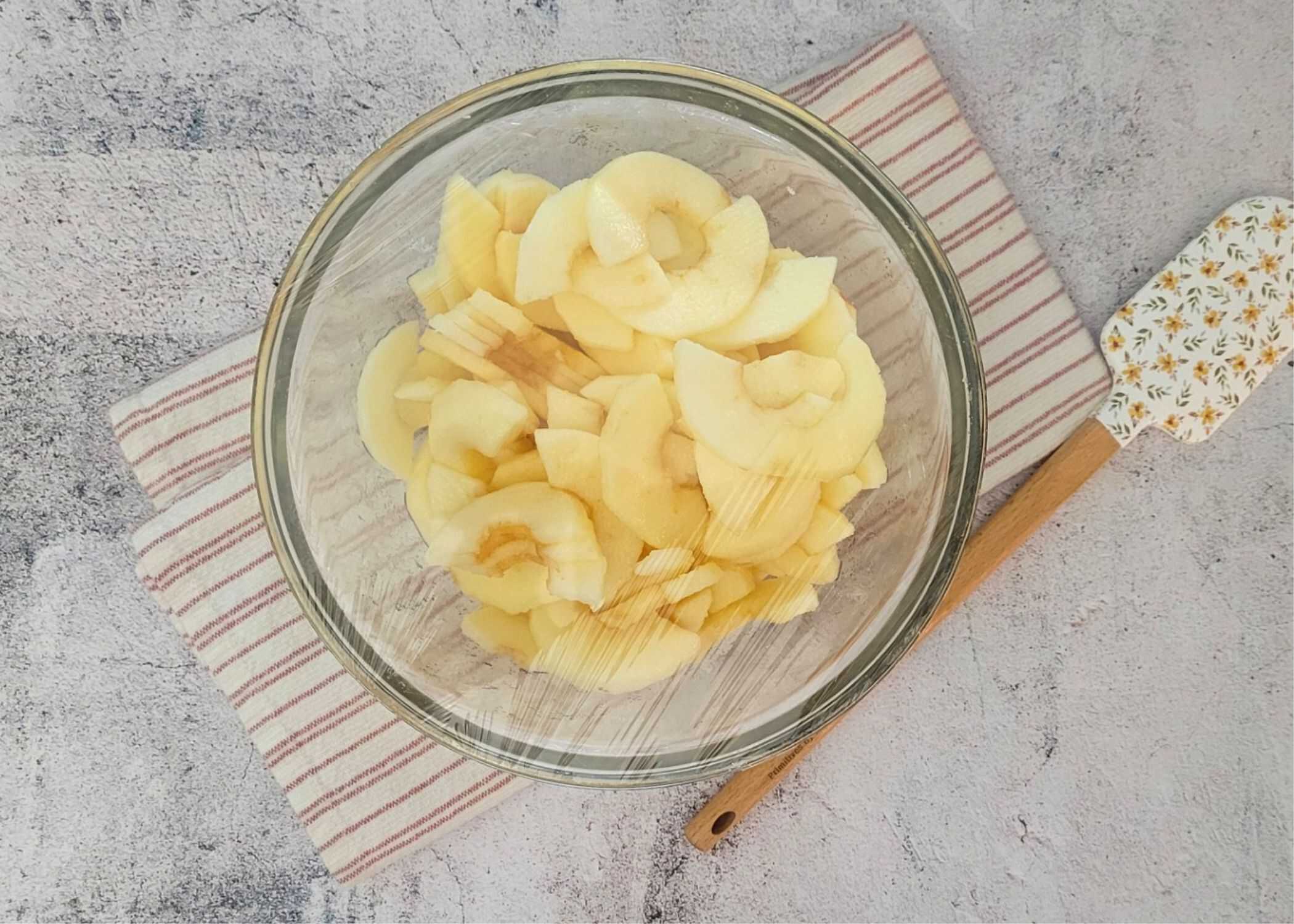 apple slices being macerated before adding to cookie bars , this is to help prevent a soggy cookie bar bottom