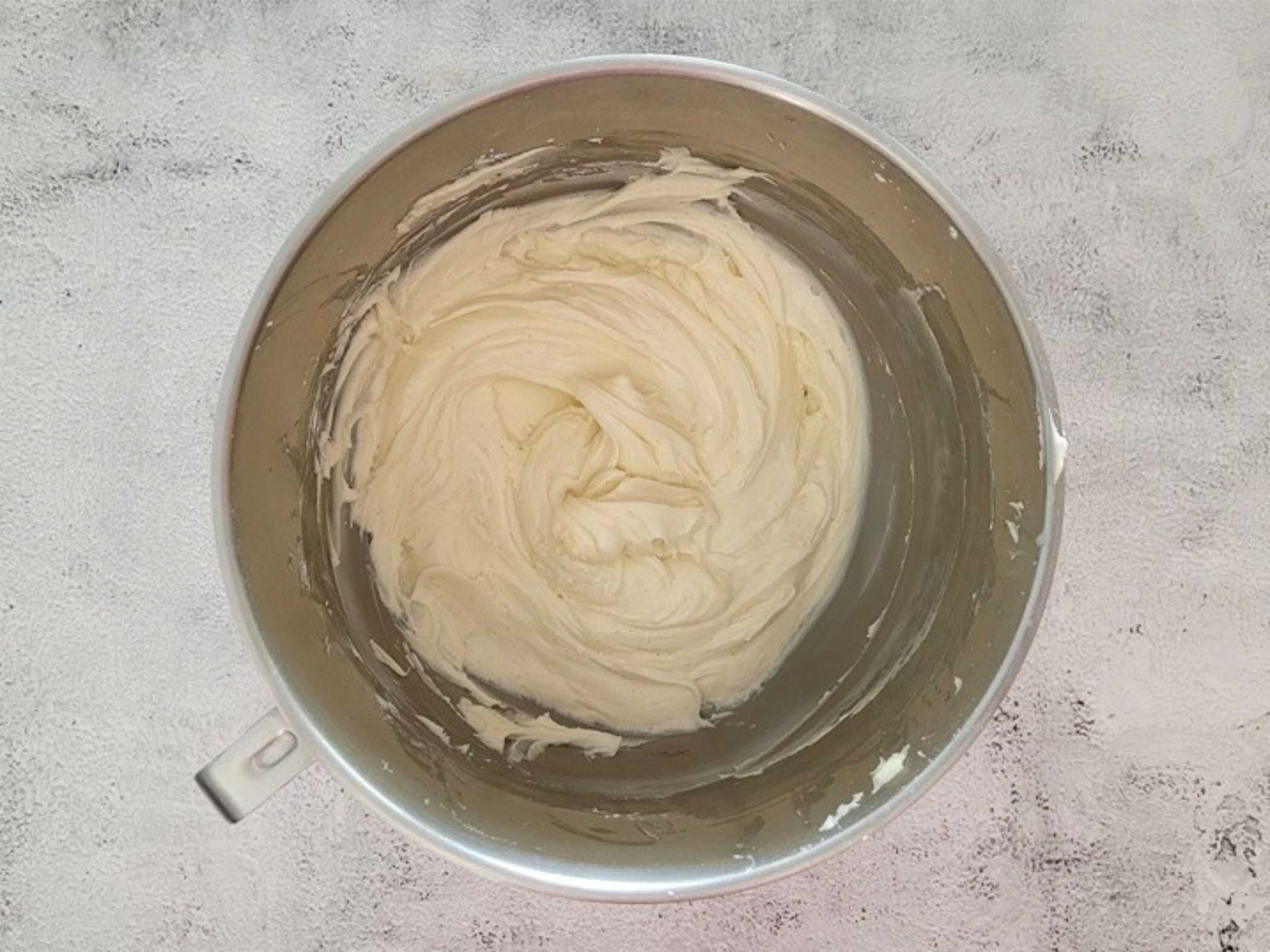 fully mixed cinnamon cream cheese frosting in a mixing bowl