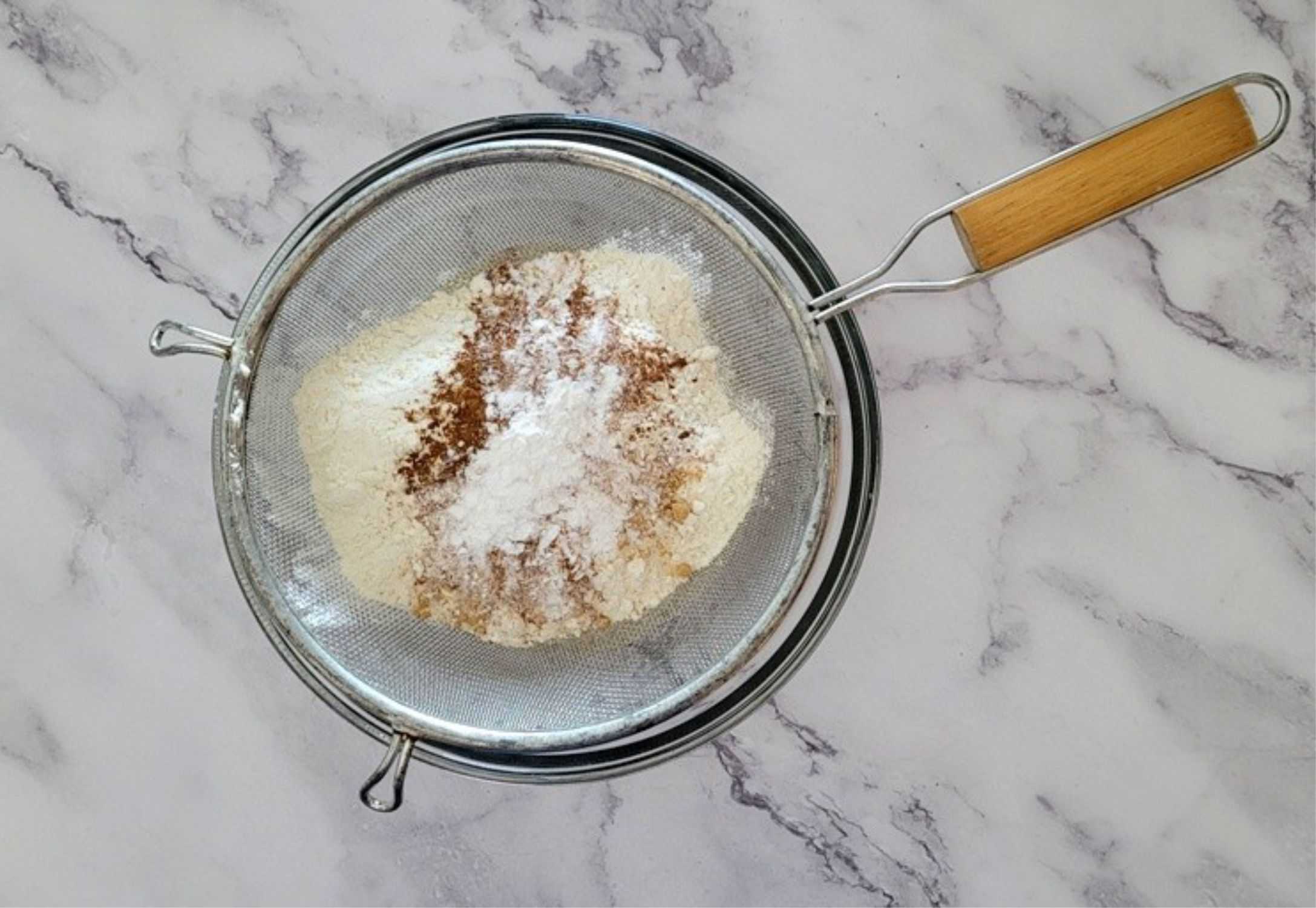 sifting together flour and spices