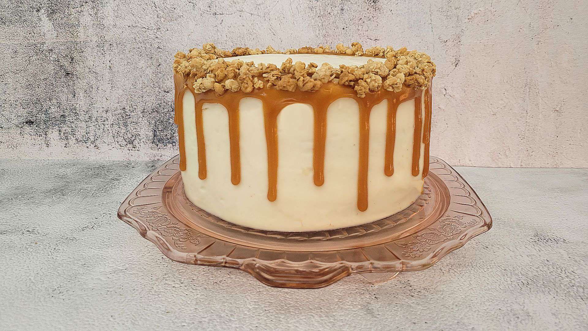 spice cake with icing and caramel dripping down the sides