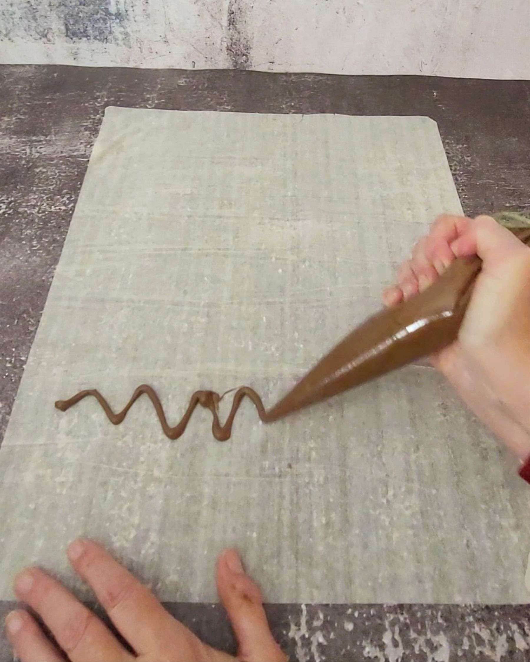 piping a line of Nutella on phyllo dough