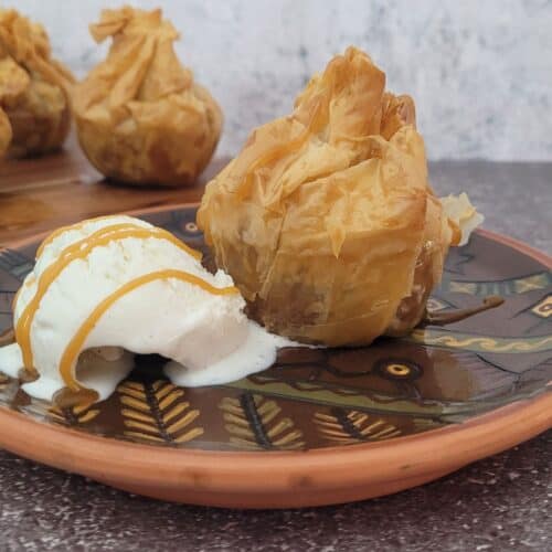 apple baklava on a plate with ice cream and caramel