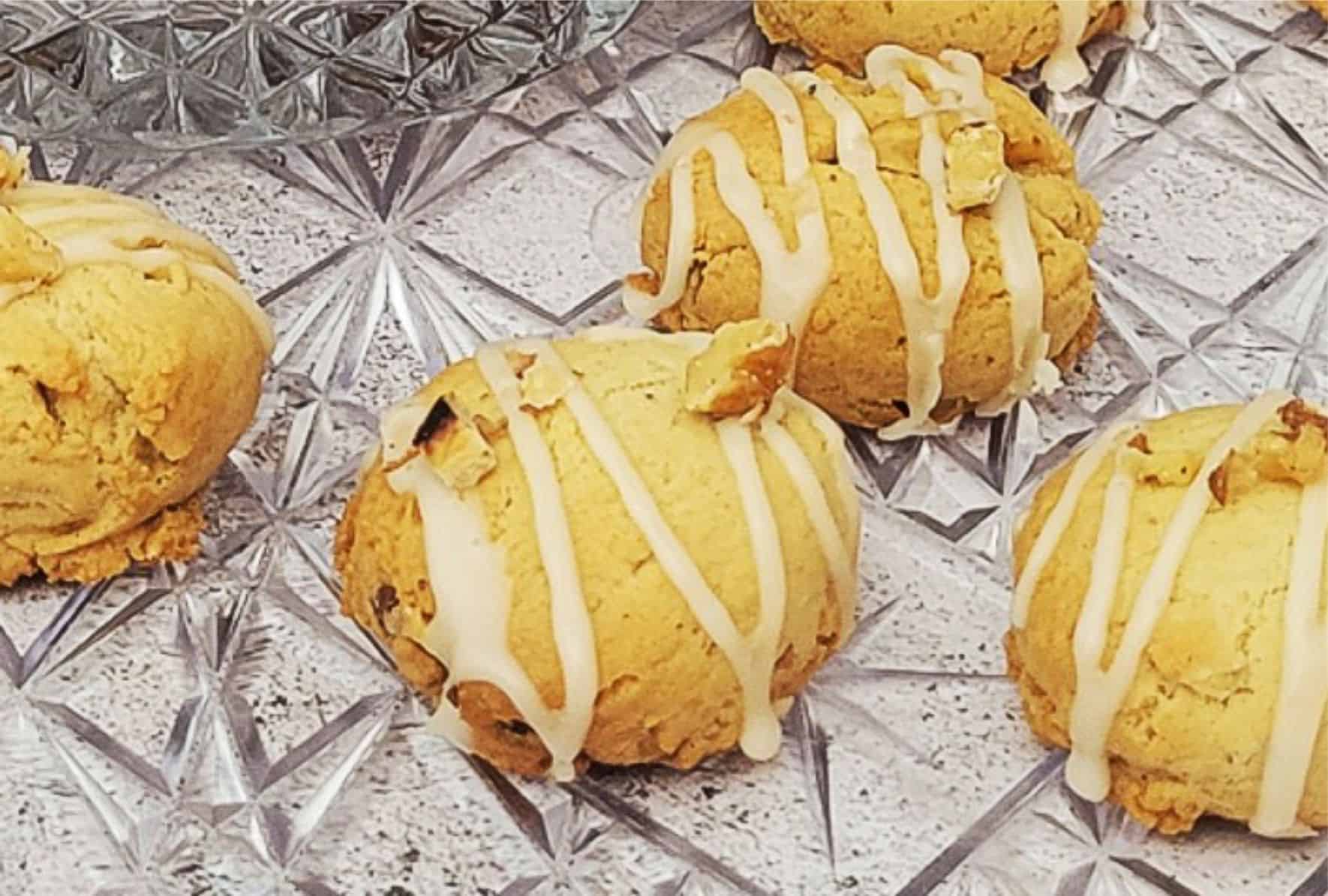 close up of cookies with maple glaze and walnut pieces