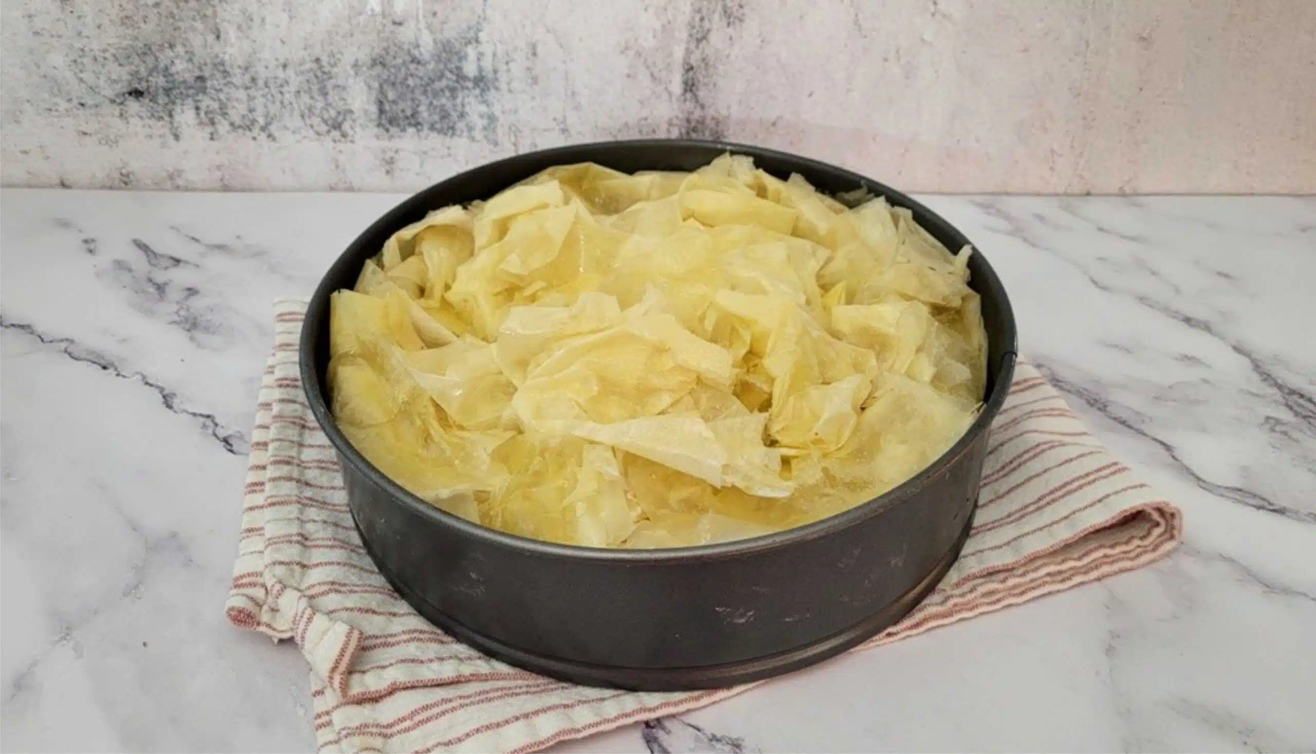 finished baklava in pan and ready for baking