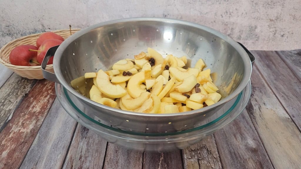 apples and raisins being drained after macerating