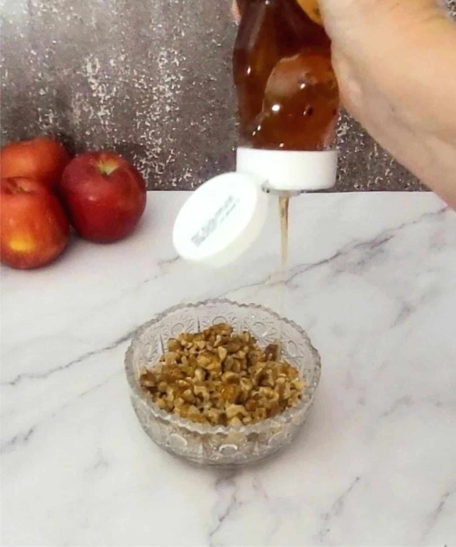 pouring honey into walnuts to make mixture for filling crinkle cake recipe