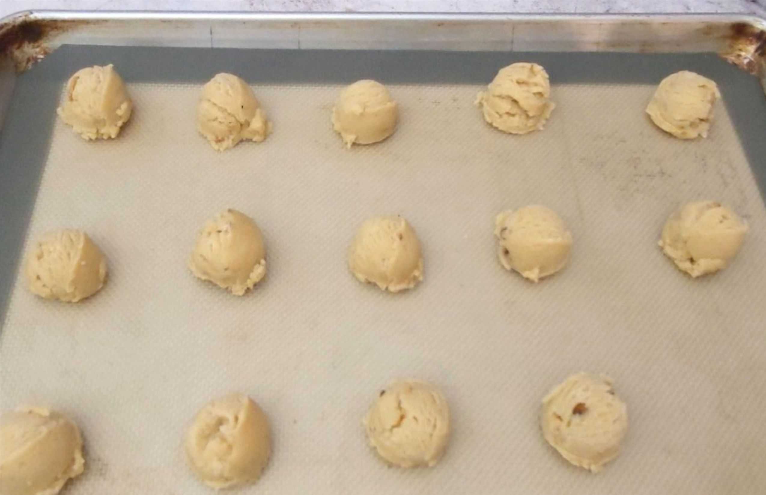 cookie dough scooped onto a baking sheet