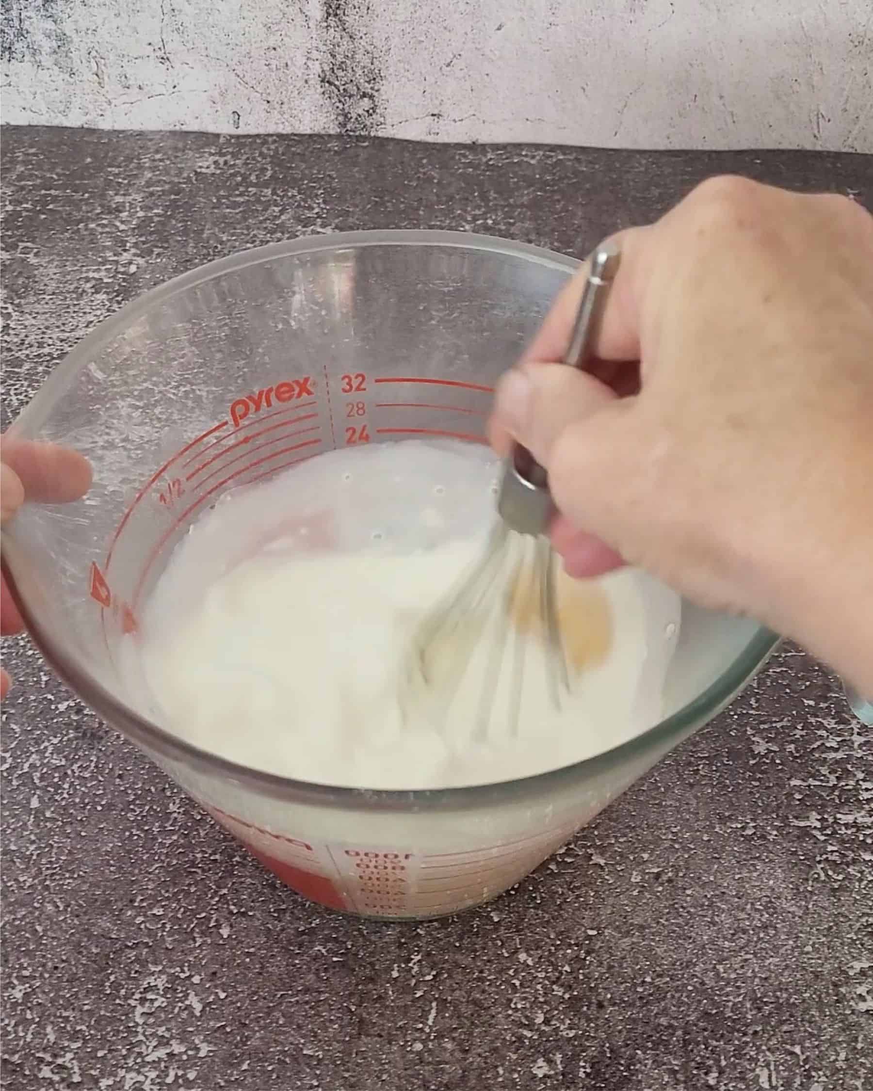 mixing together heavy cream, eggs and granulated sugar to make custard filling