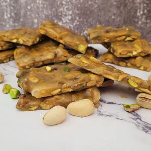 pieces of broken up candy brittle with pistachio nuts