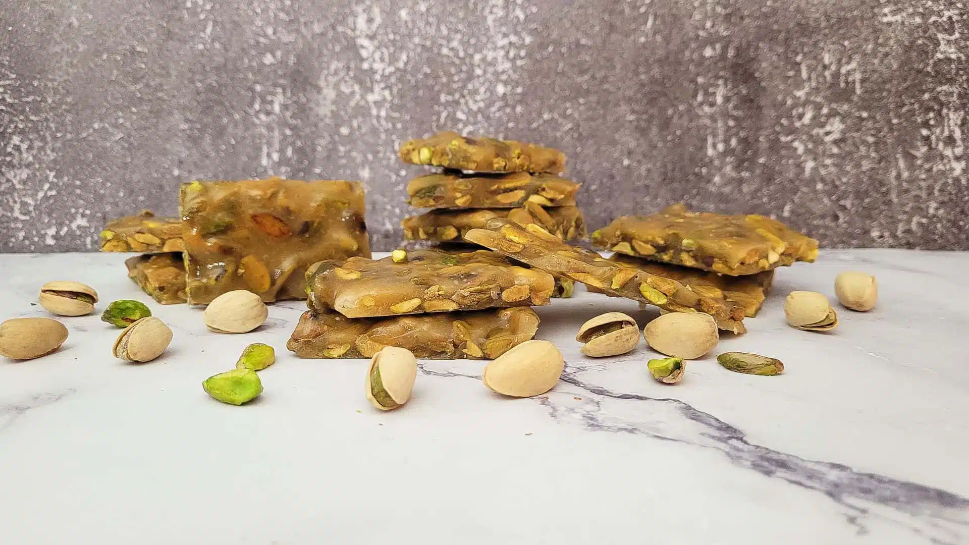 Pistachio nut brittle on a marble tabletop