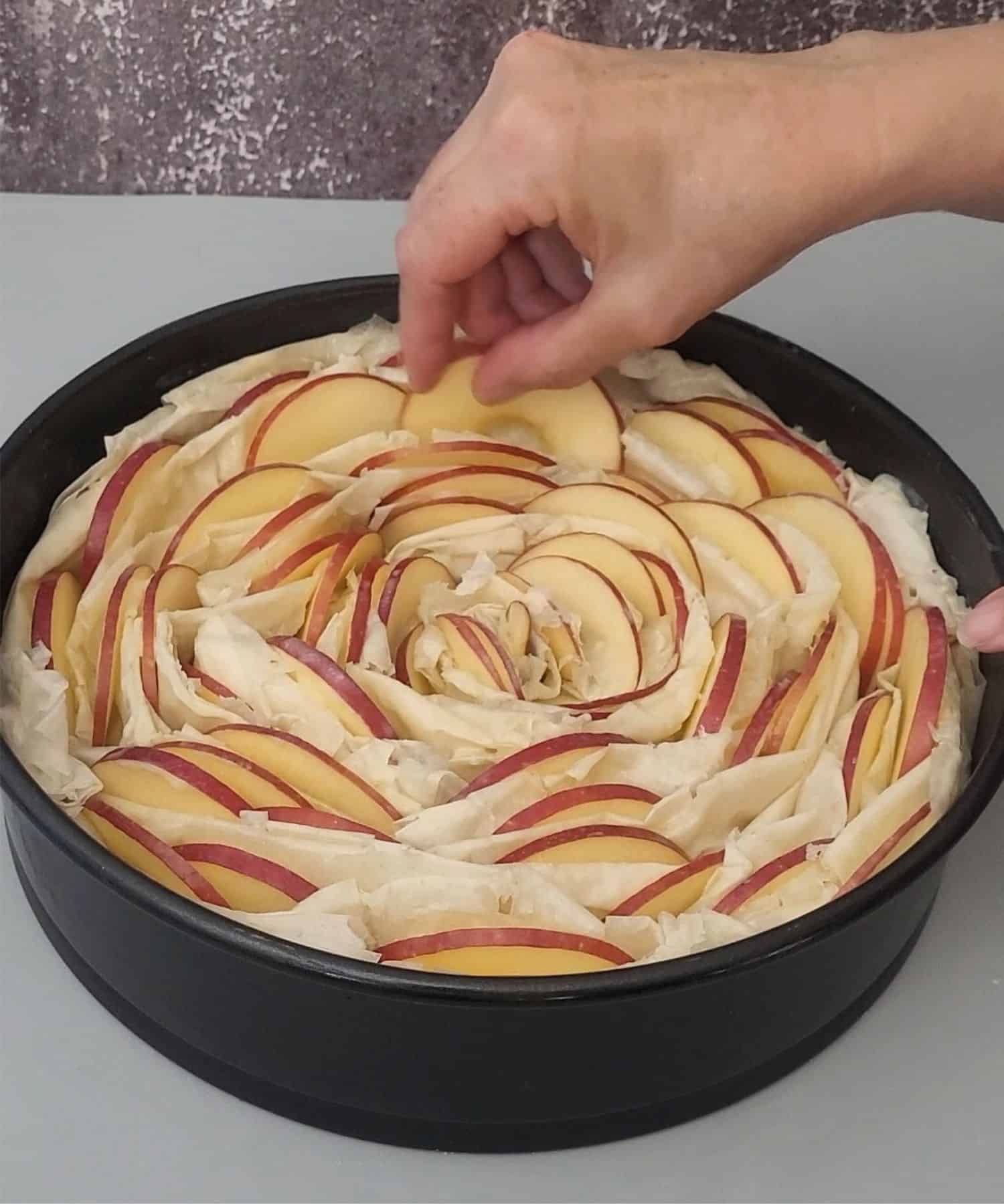 inserting thin apple slices between phyllo layers