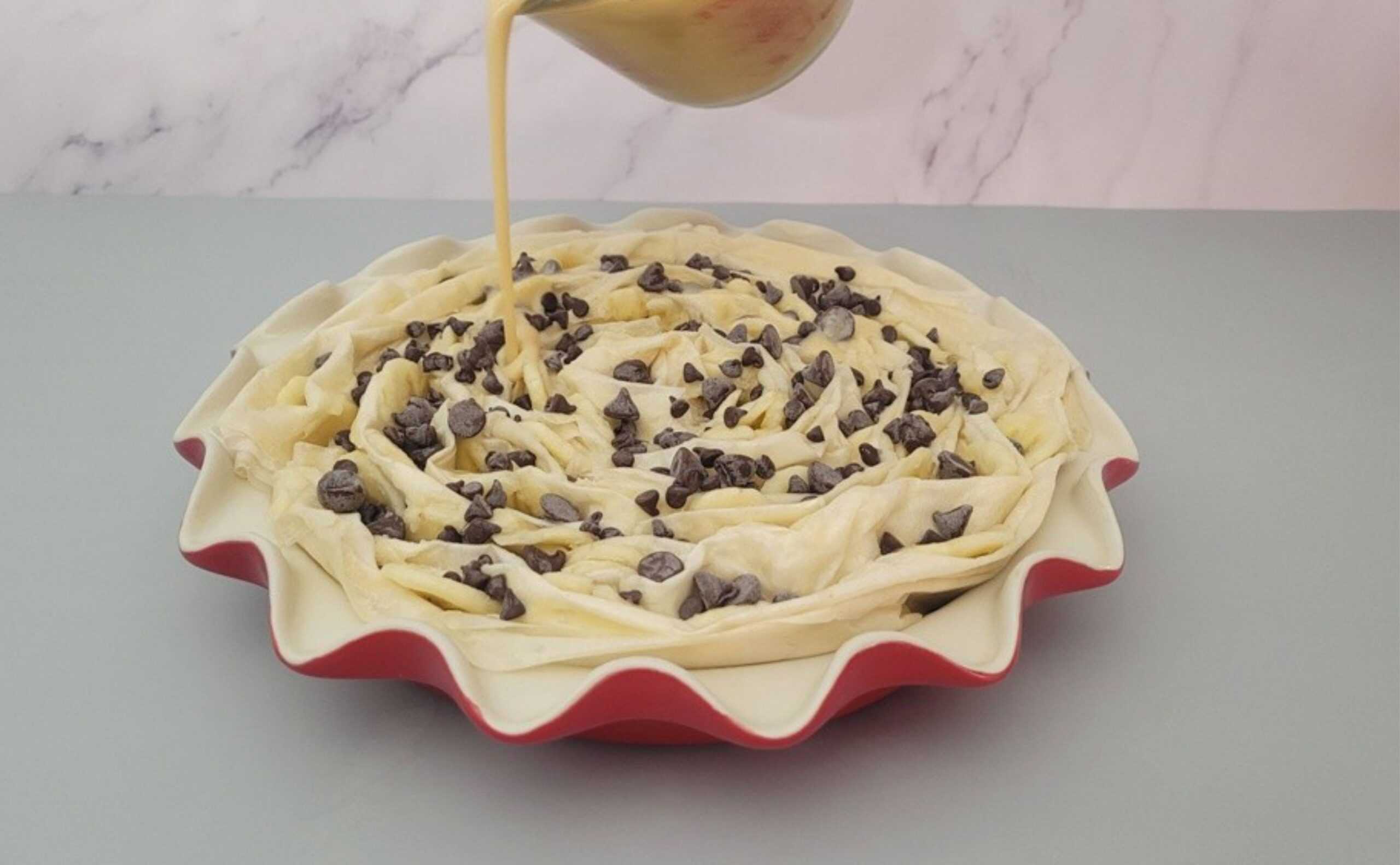 pouring cinnamon custard filling into pie pan