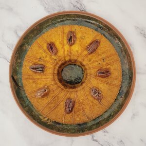 overhead view of a pumpkin chiffon cake with candied pecans on top