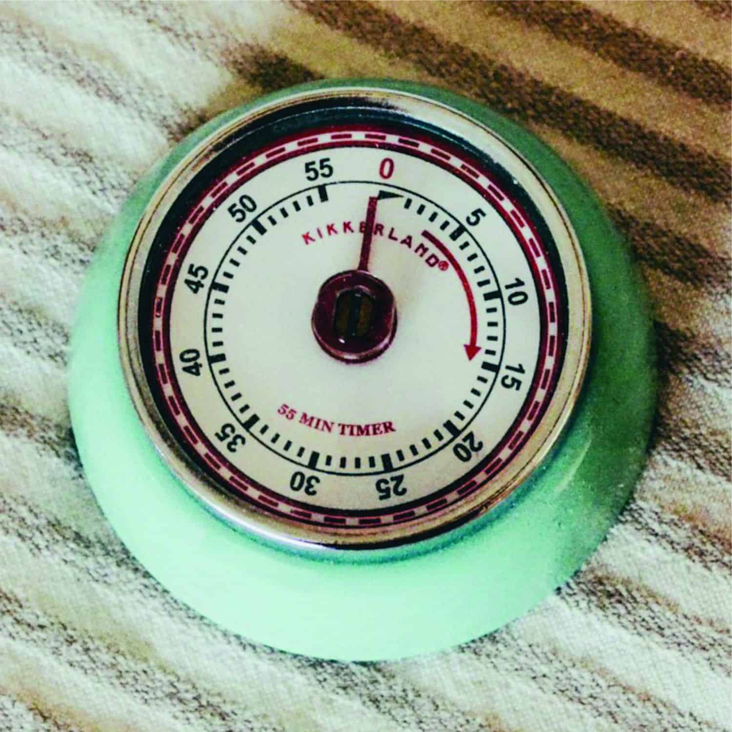 overhead view of a green kitchen timer on a napkin