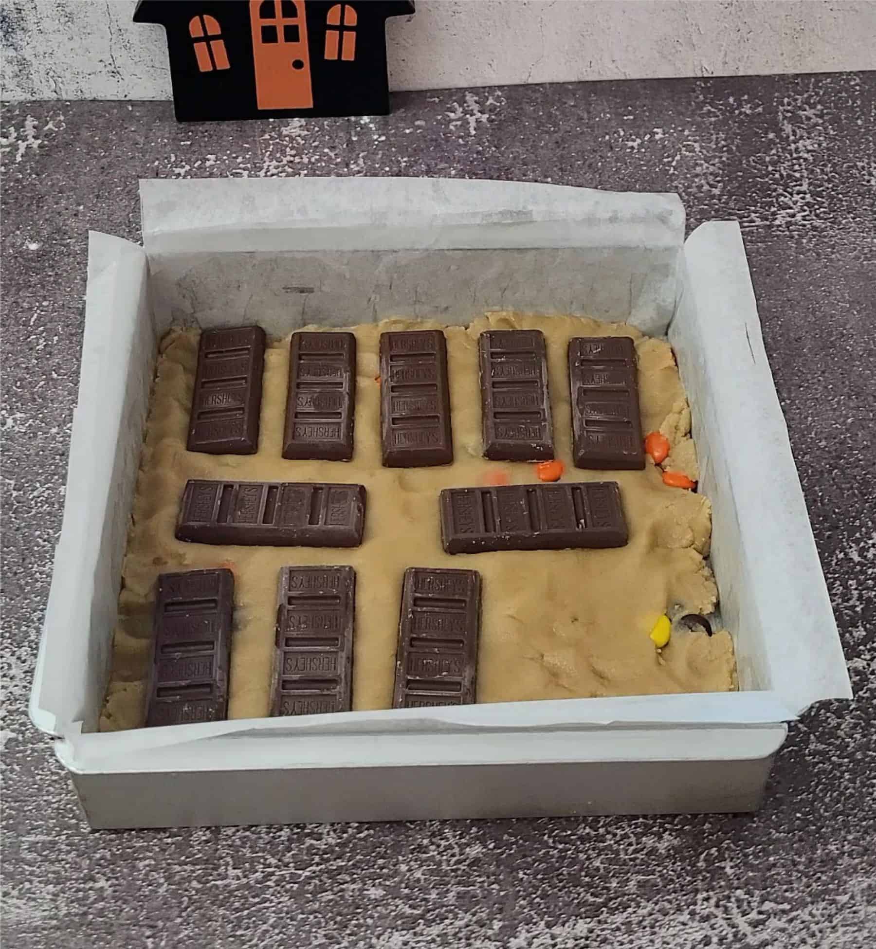 Halloween candy bars on top of blondie cookie dough