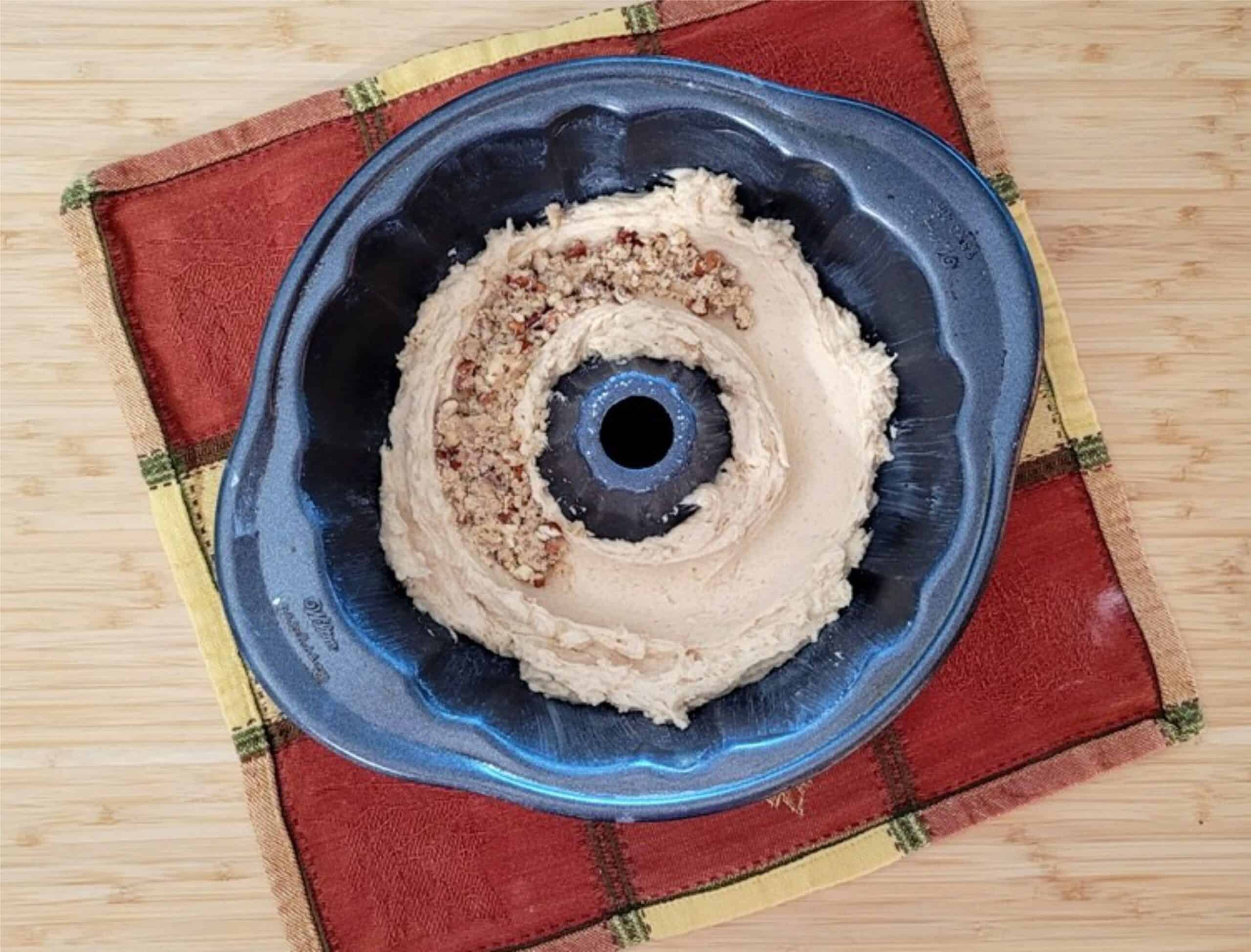 pecan streusel filling added to a tunnel in cake batter