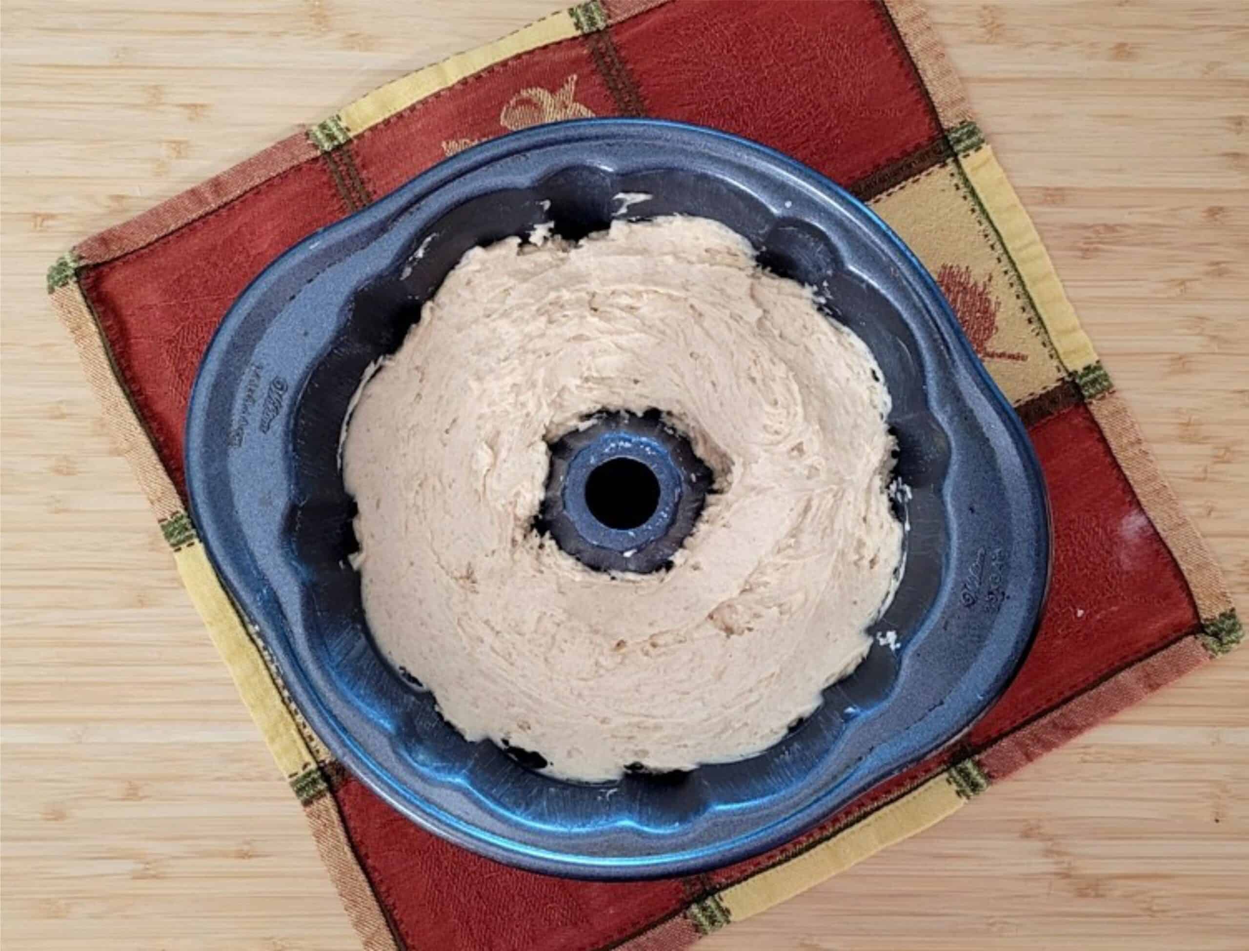 Bundt pan with cake batter added and ready for baking