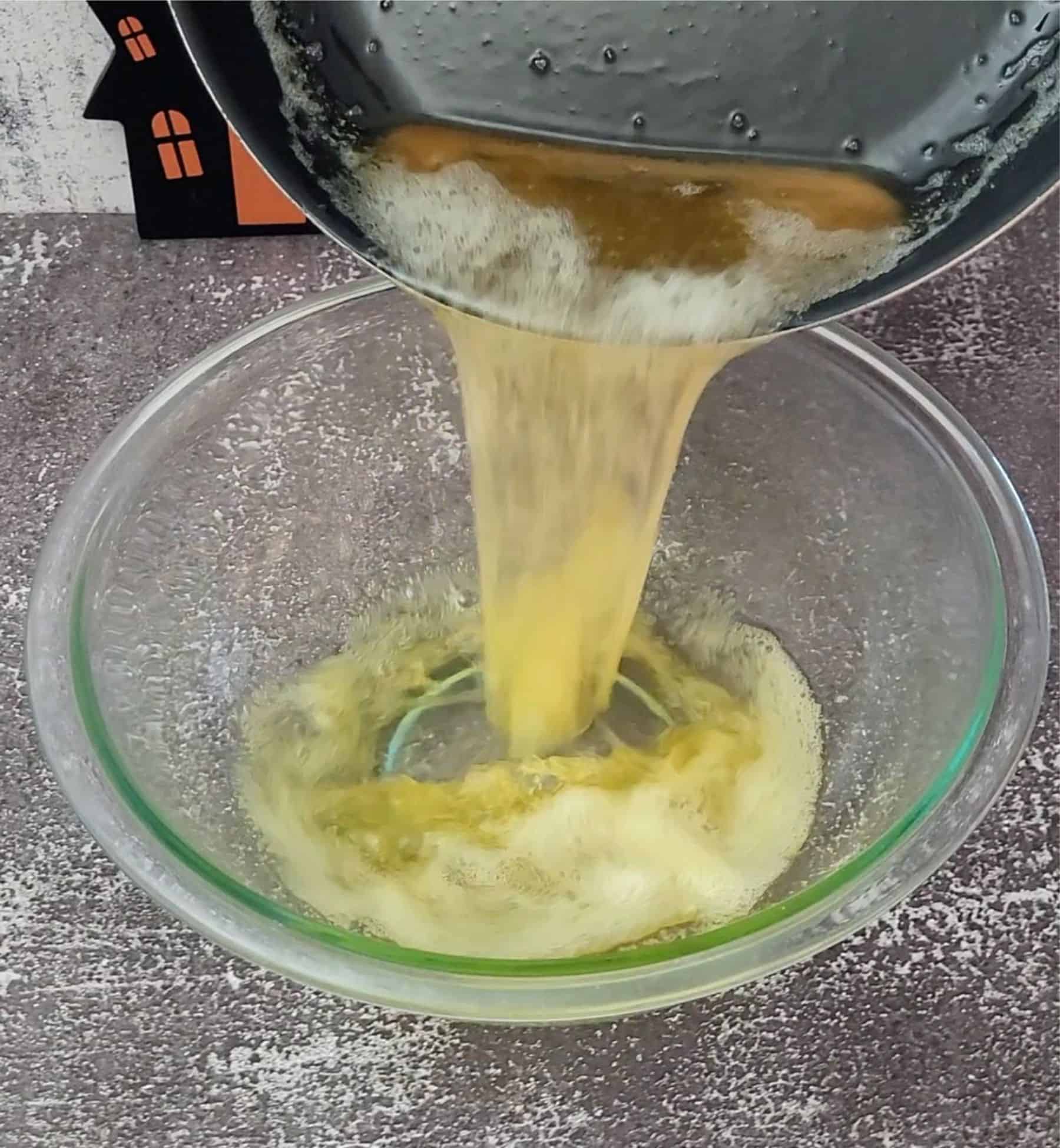 pouring brown butter into bowl to cool before making blondie dough