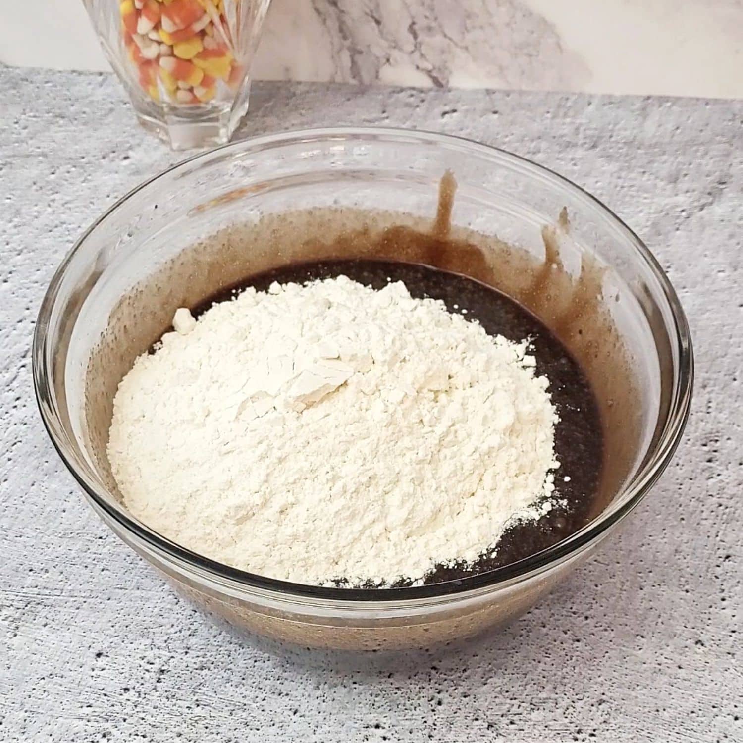 flour and salt added to brownie batter mixing bowl