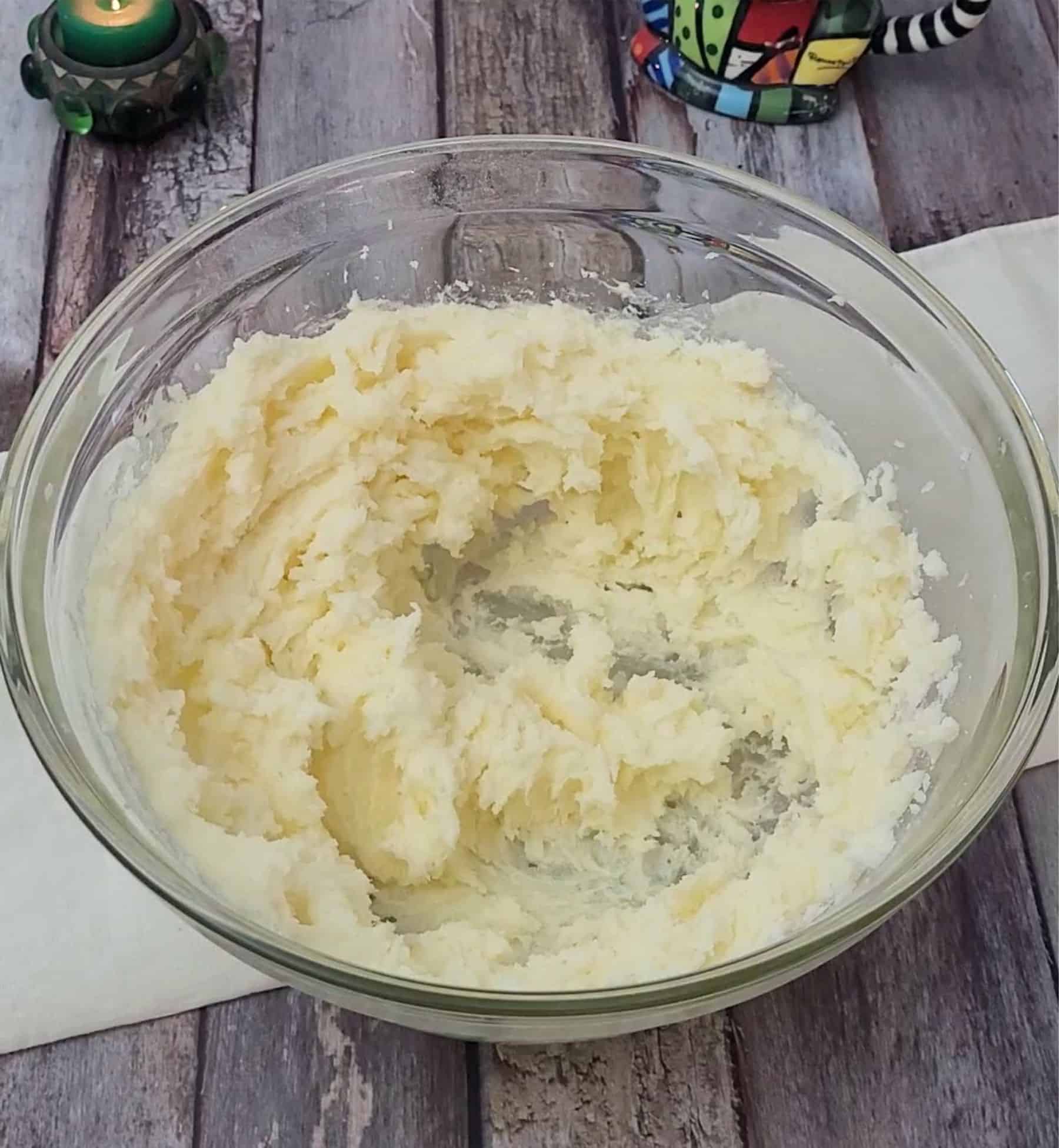 butter and granulated sugar mixing together in a bowl to make base for dessert cookie bars