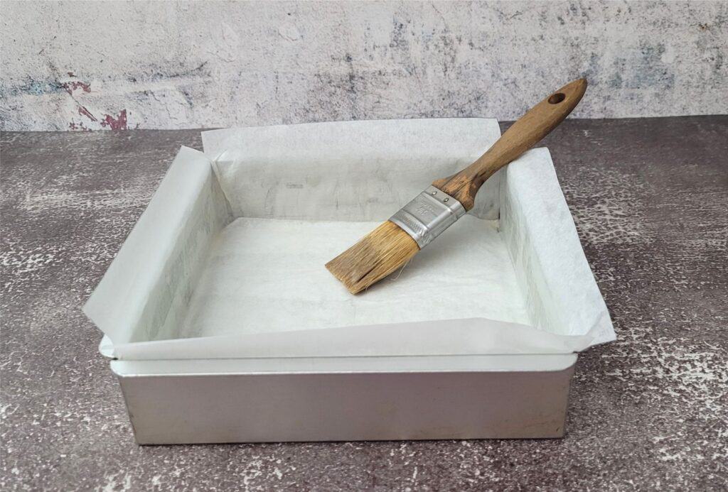 8 inch square pan prepared by lining with parchment paper and apply butter to paper