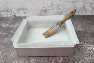 8 inch square pan prepared by lining with parchment paper and apply butter to paper