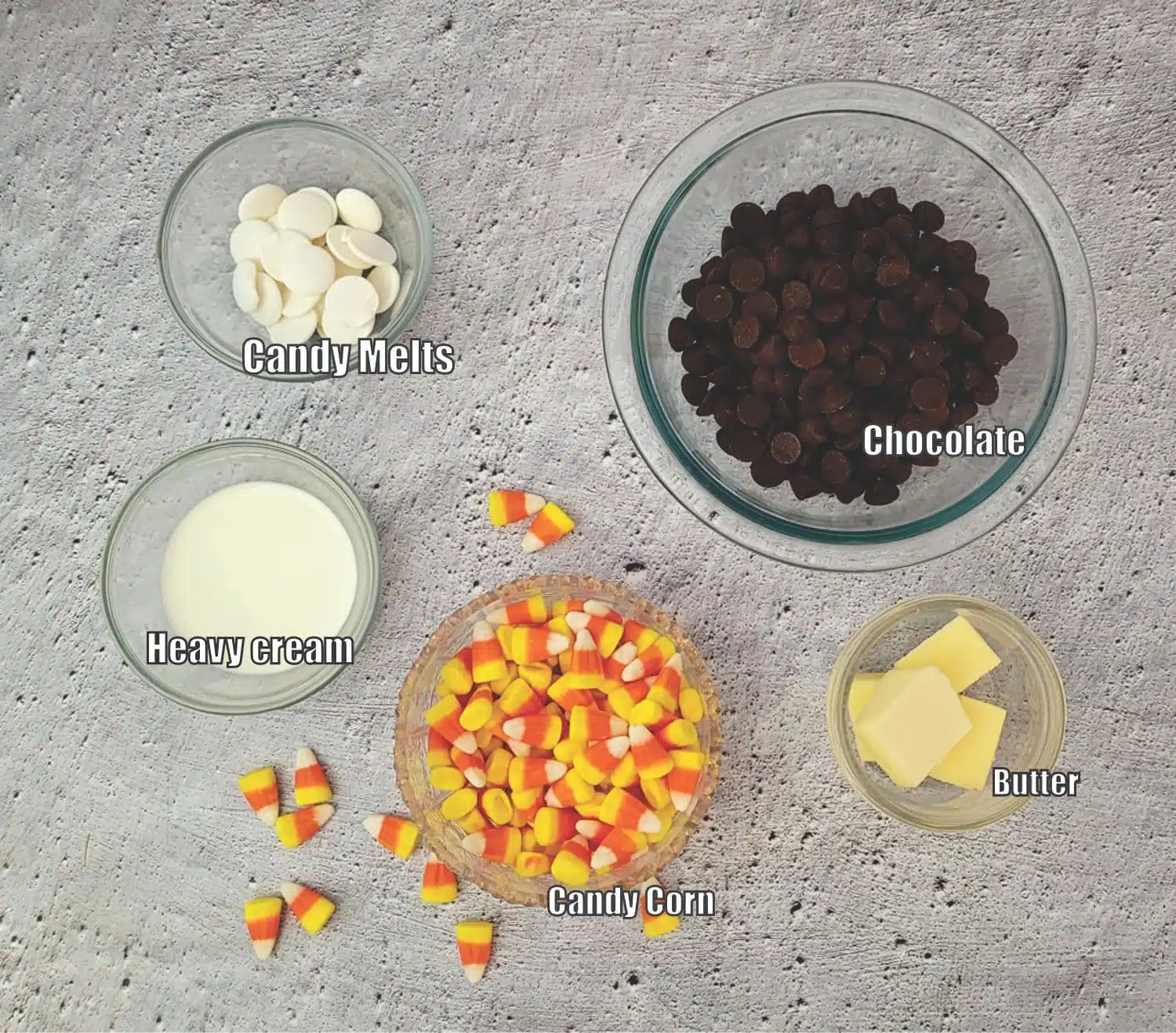 topping ingredients for brownies, including leftover candy corn, heavy cream, chocolate, butter and white candy melts