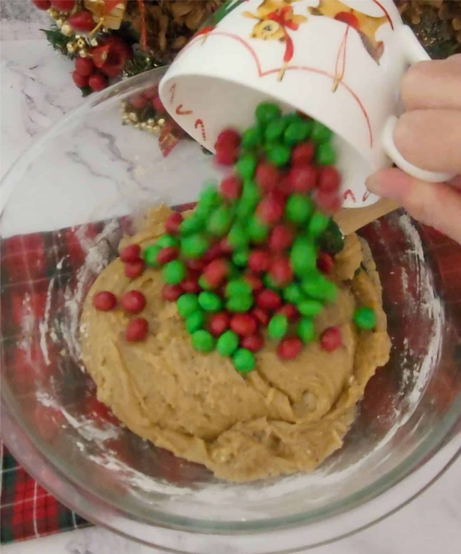 Christmas colored M&Ms added to mixing bowl