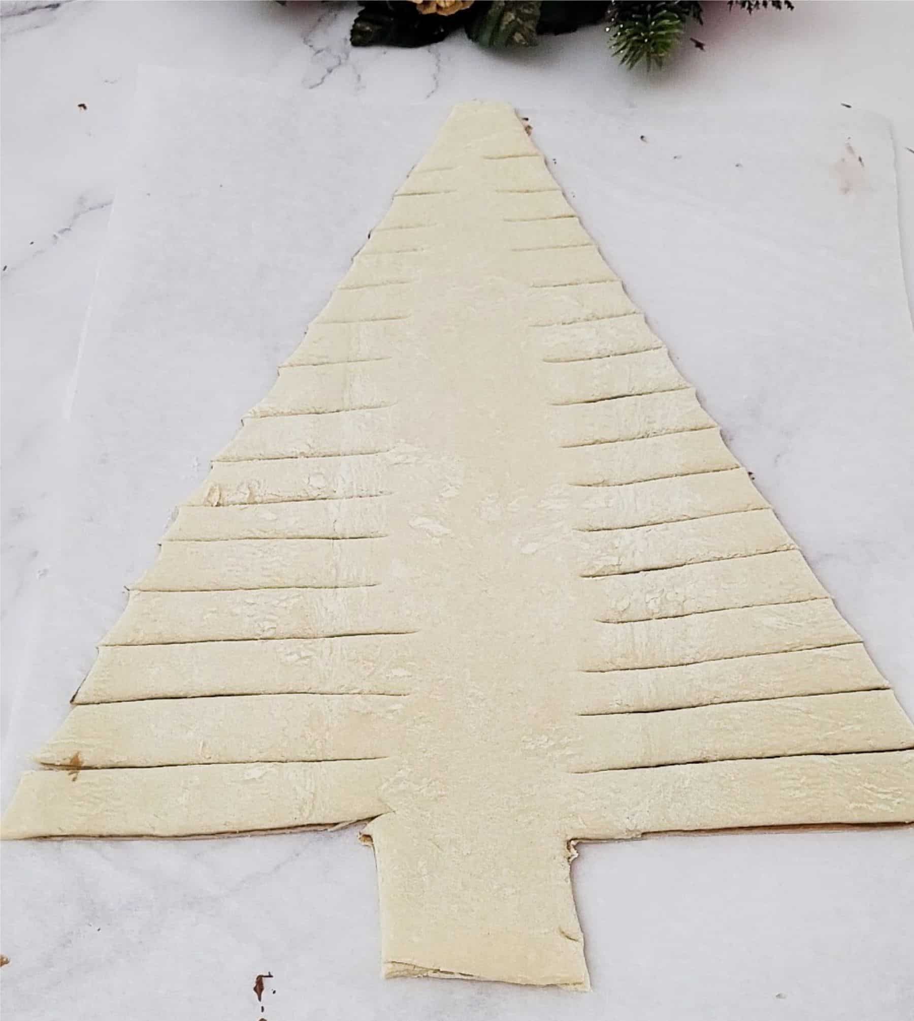 finished pastry with slits cut out before twisting ends