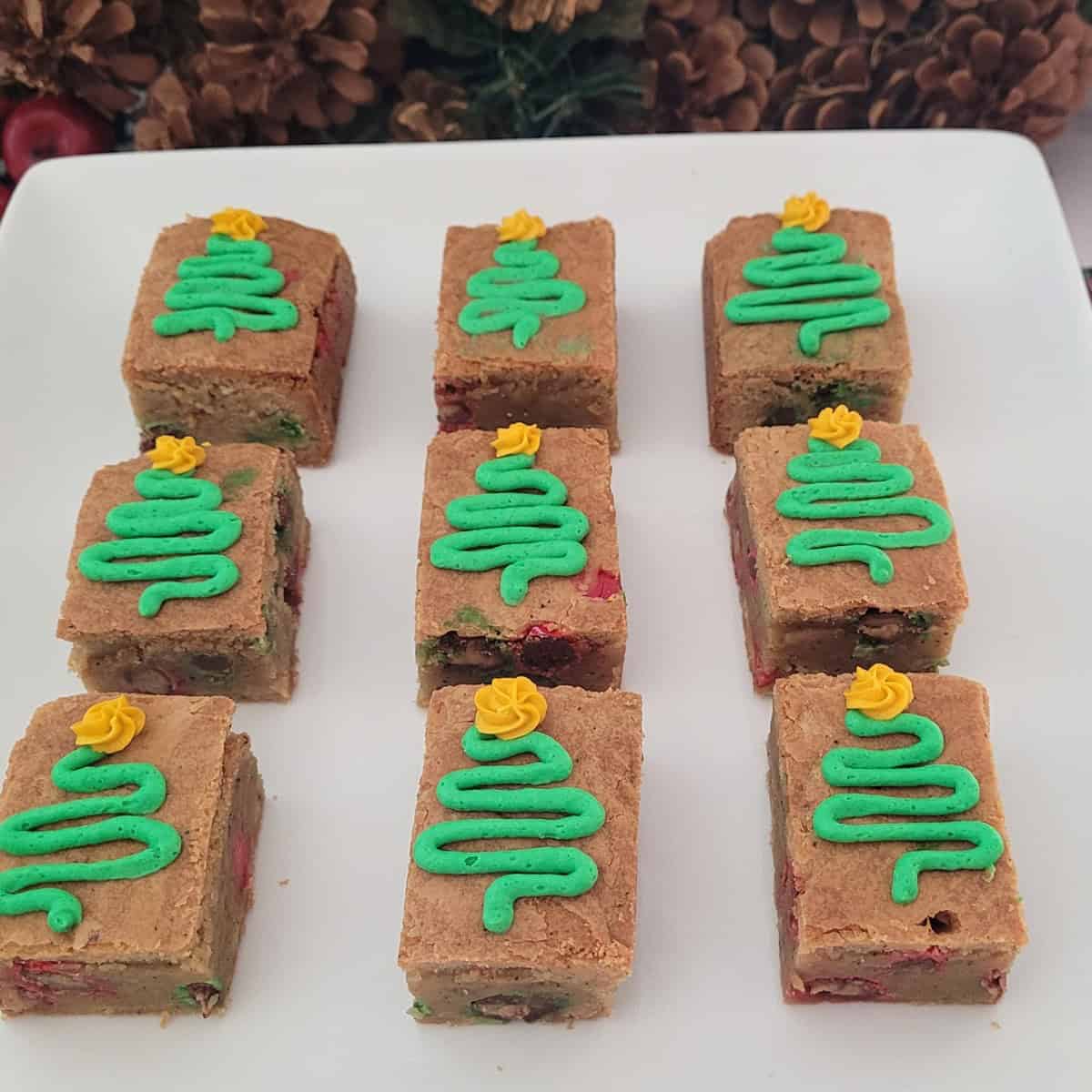 brown butter blondies with buttercream Christmas trees piped onto each piece