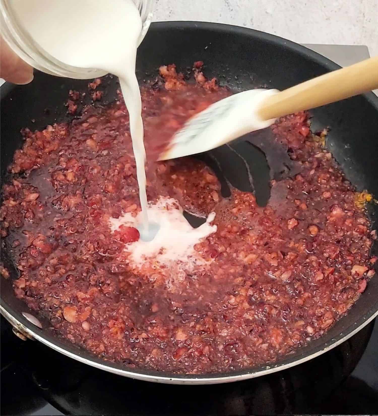 pouring cornstarch into saucepan to thicken galette and avoid a runny filling