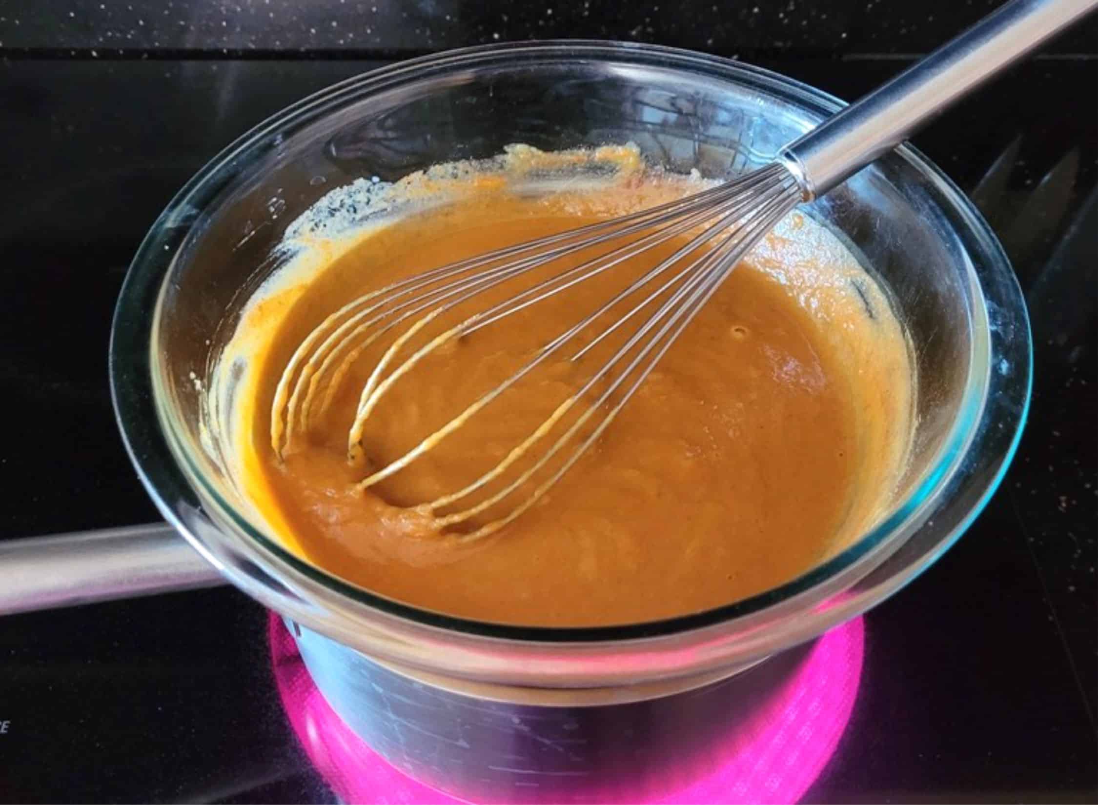 heating pumpkin mixture over a pot of steaming water