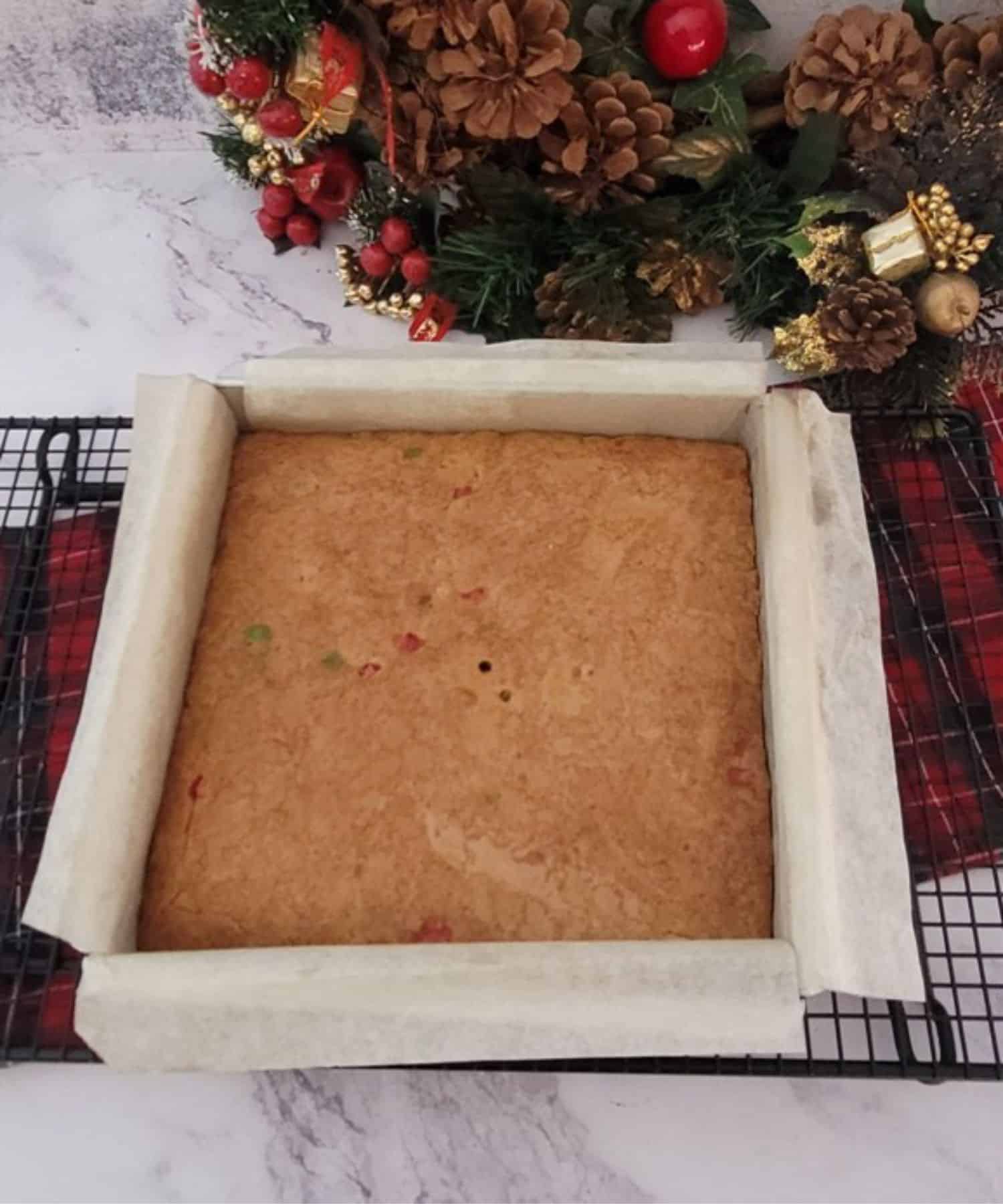 Christmas brown butter blondies in baking pan cooling on a wire rack after cooking