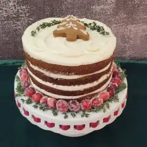 holiday gingerbread cake on a white cake stand