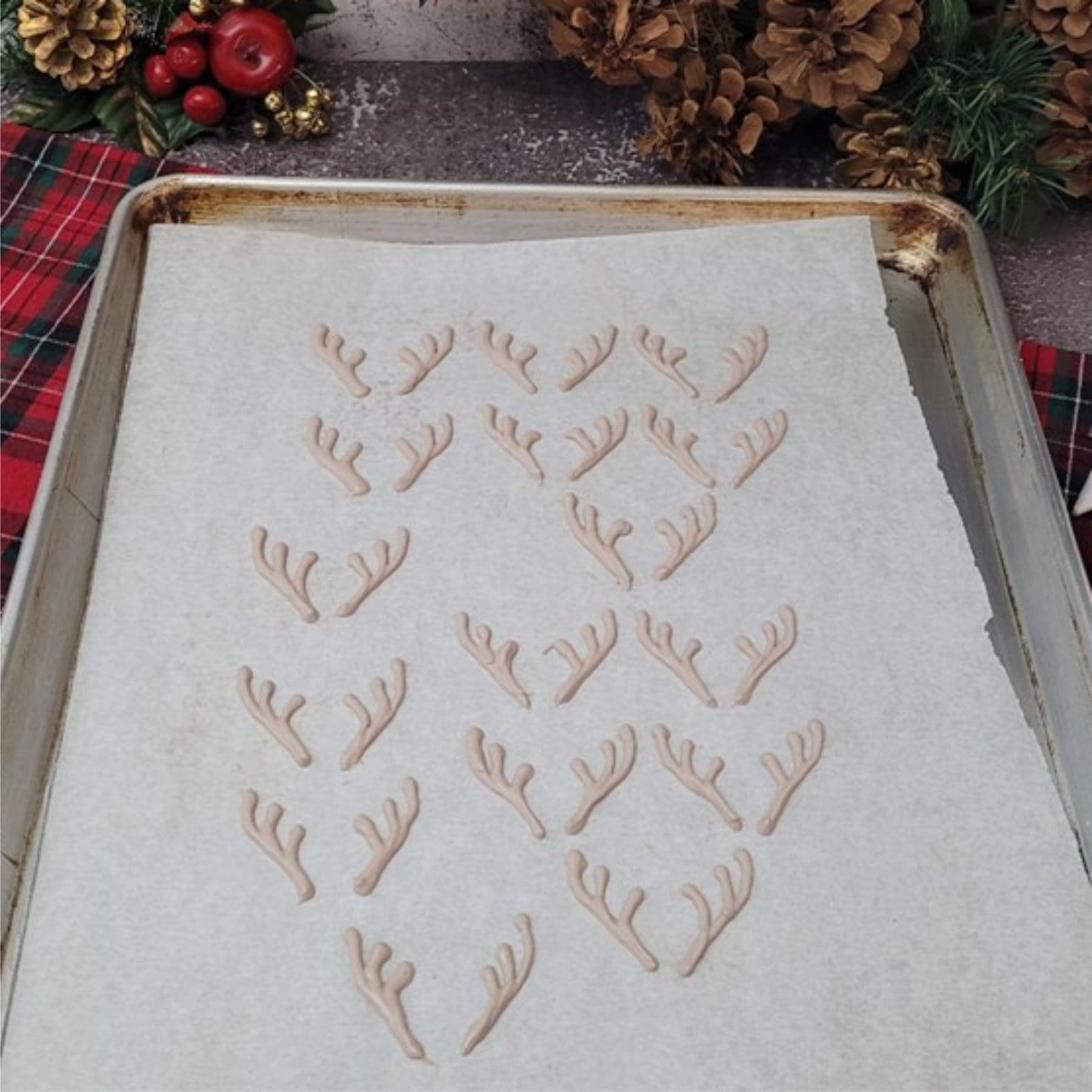 reindeer antlers piped onto parchment paper using melted chocolate