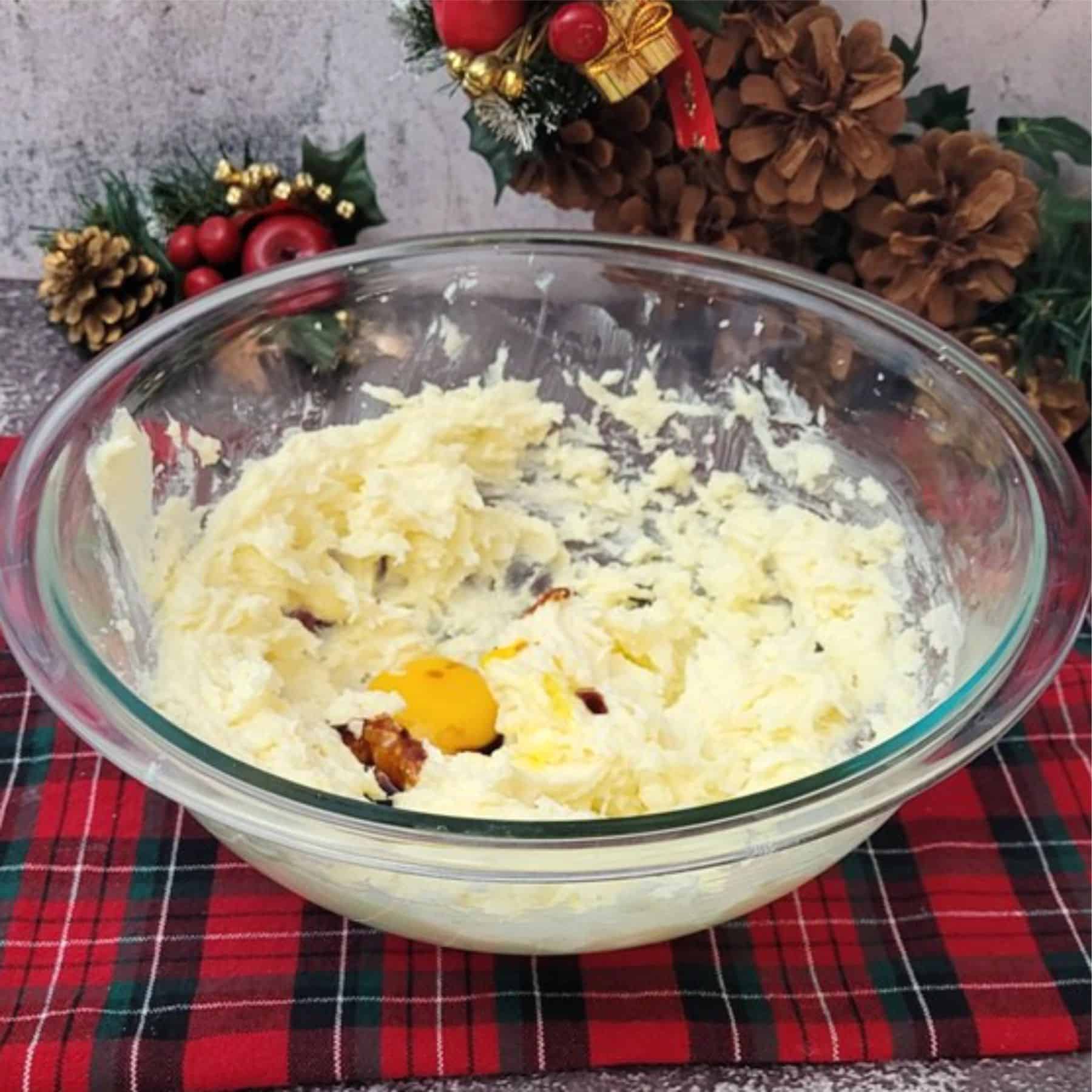 egg yolk and vanilla added to mixing bowl with butter and sugar