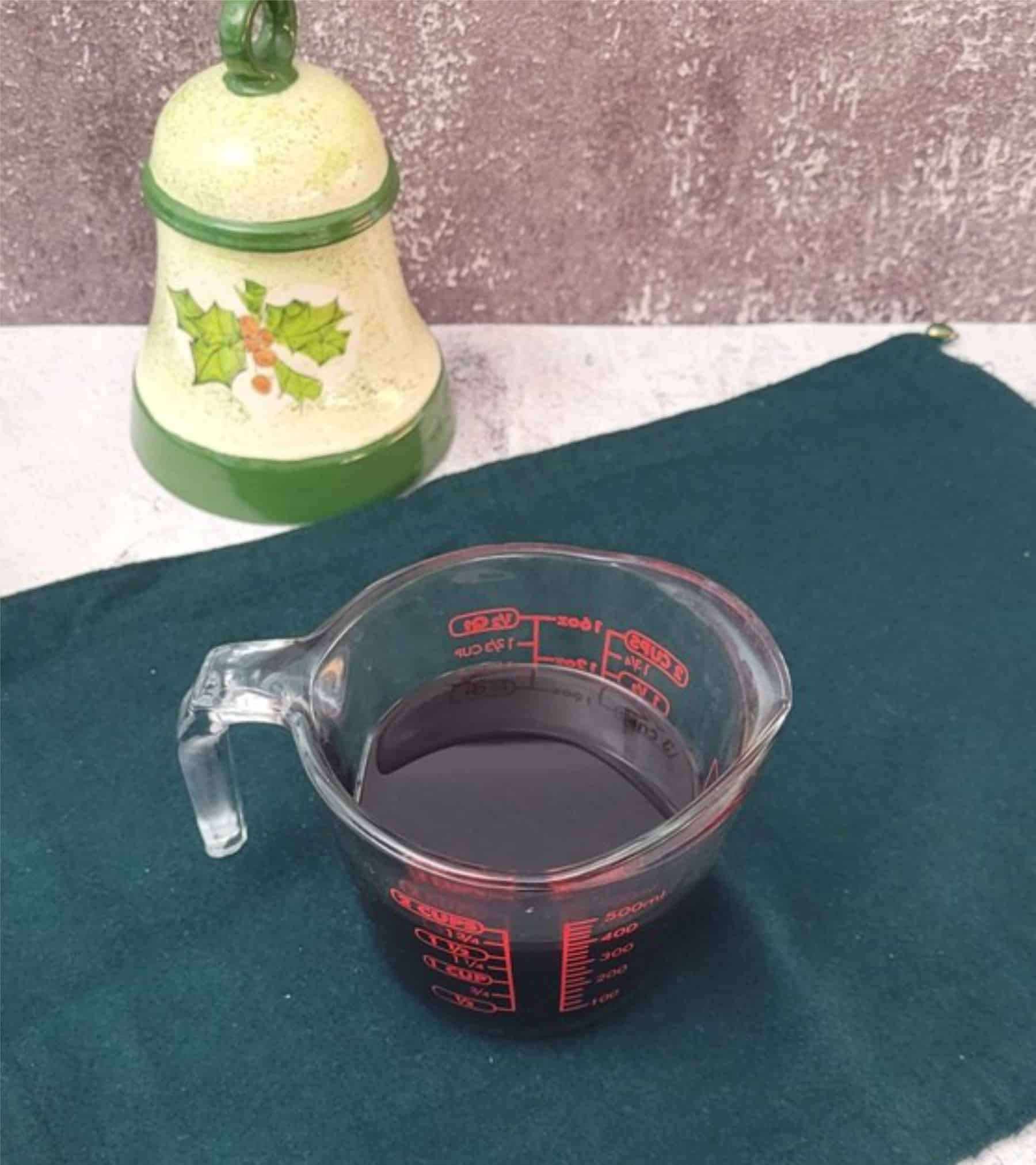 molasses and hot water mixed together in a measuring cup