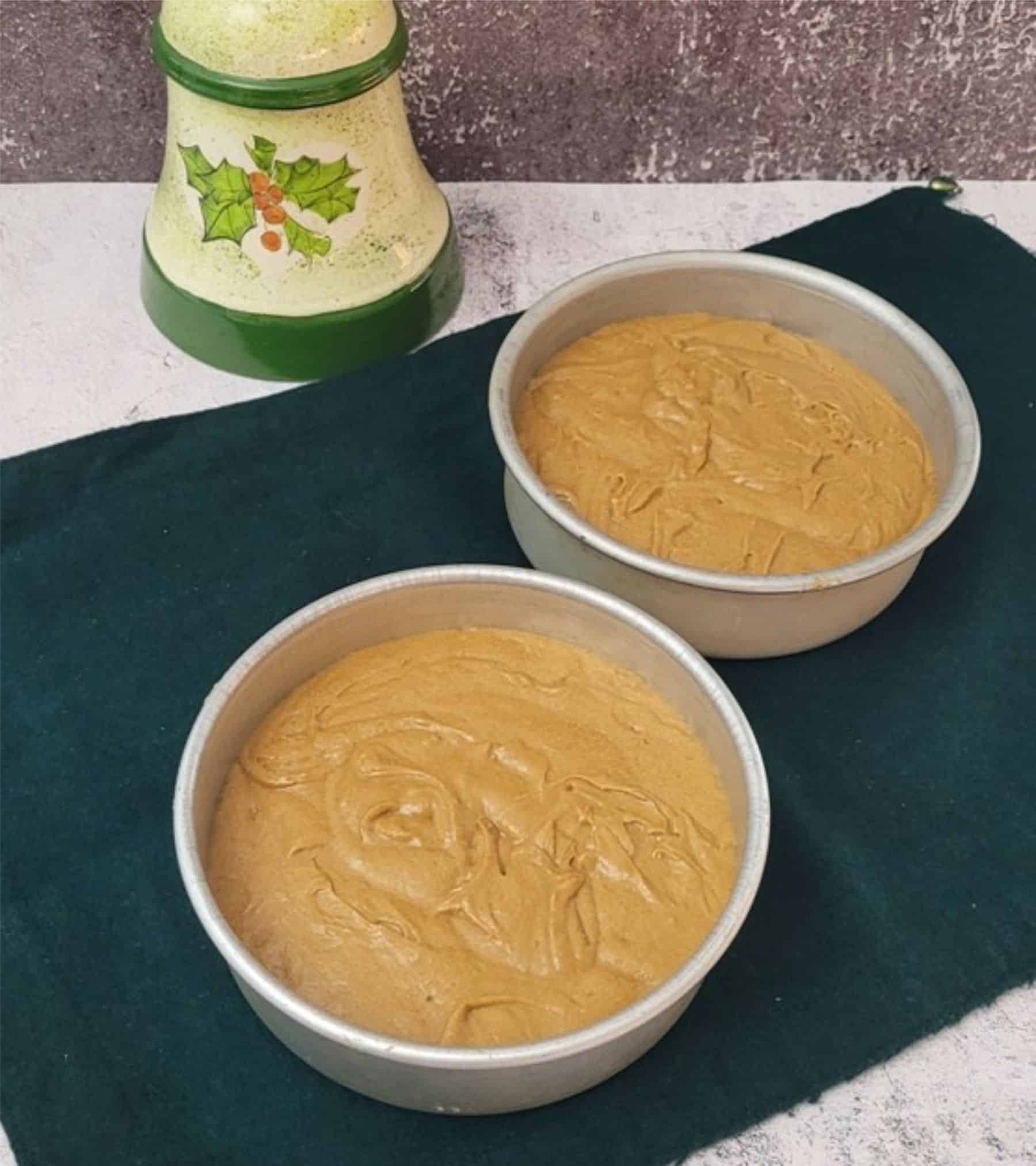 cake batter from gingerbread cake recipe poured into two pans and ready for baking