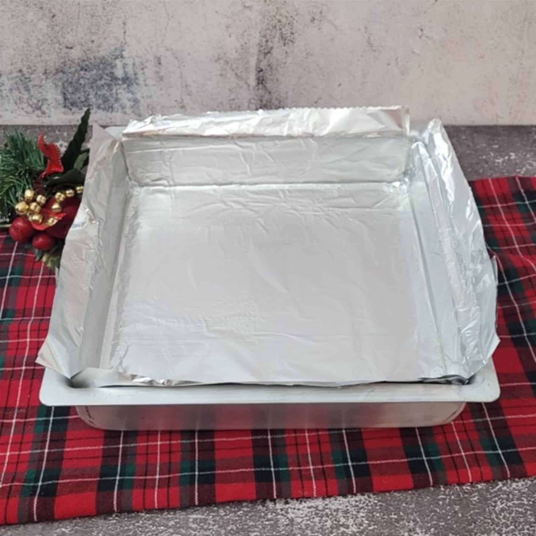 nine inch square baking pan prepared with foil before making homemade Christmas shortbread