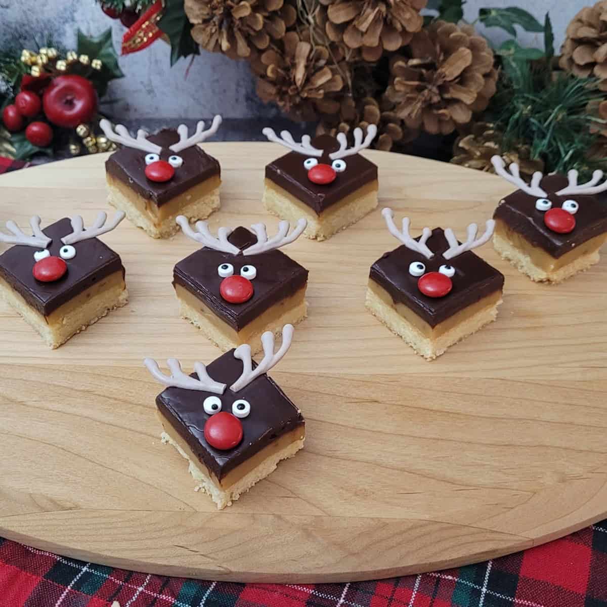 several homemade shortbread caramel squares decorated like reindeer for Christmas