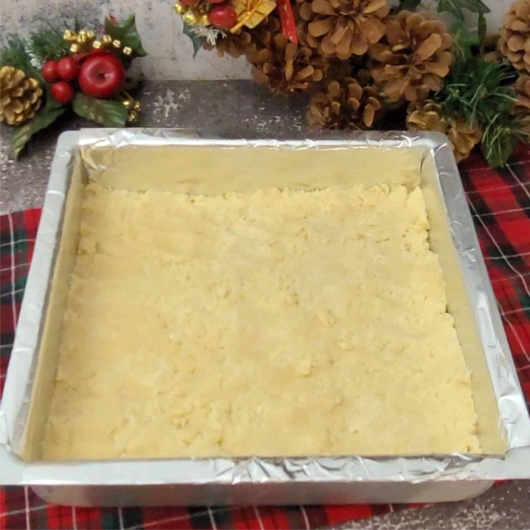 shortbread dough pressed into square pan before baking