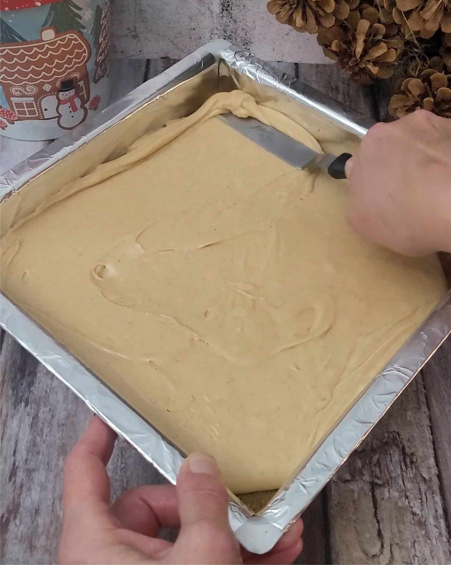 spreading gingerbread fudge over cookie crust