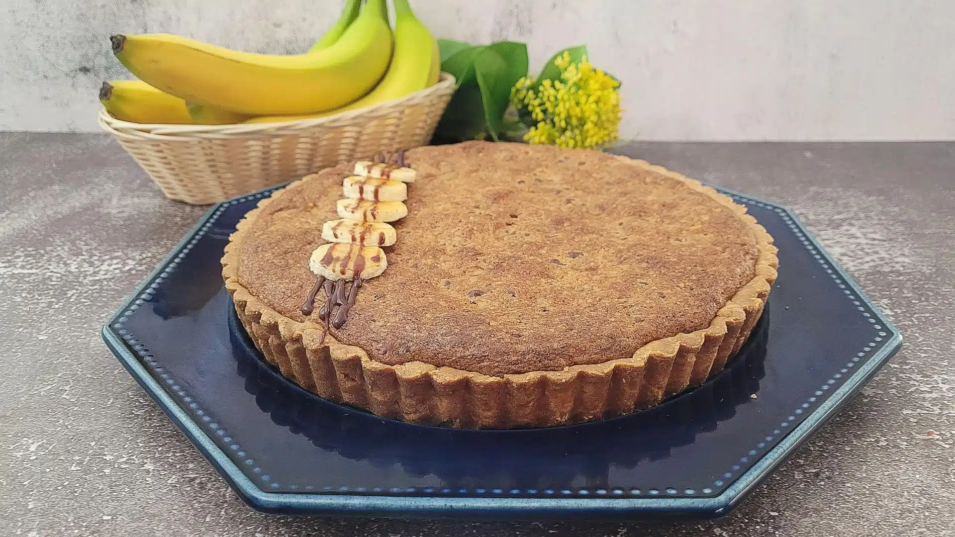 tart on a serving tray with bananas in the background