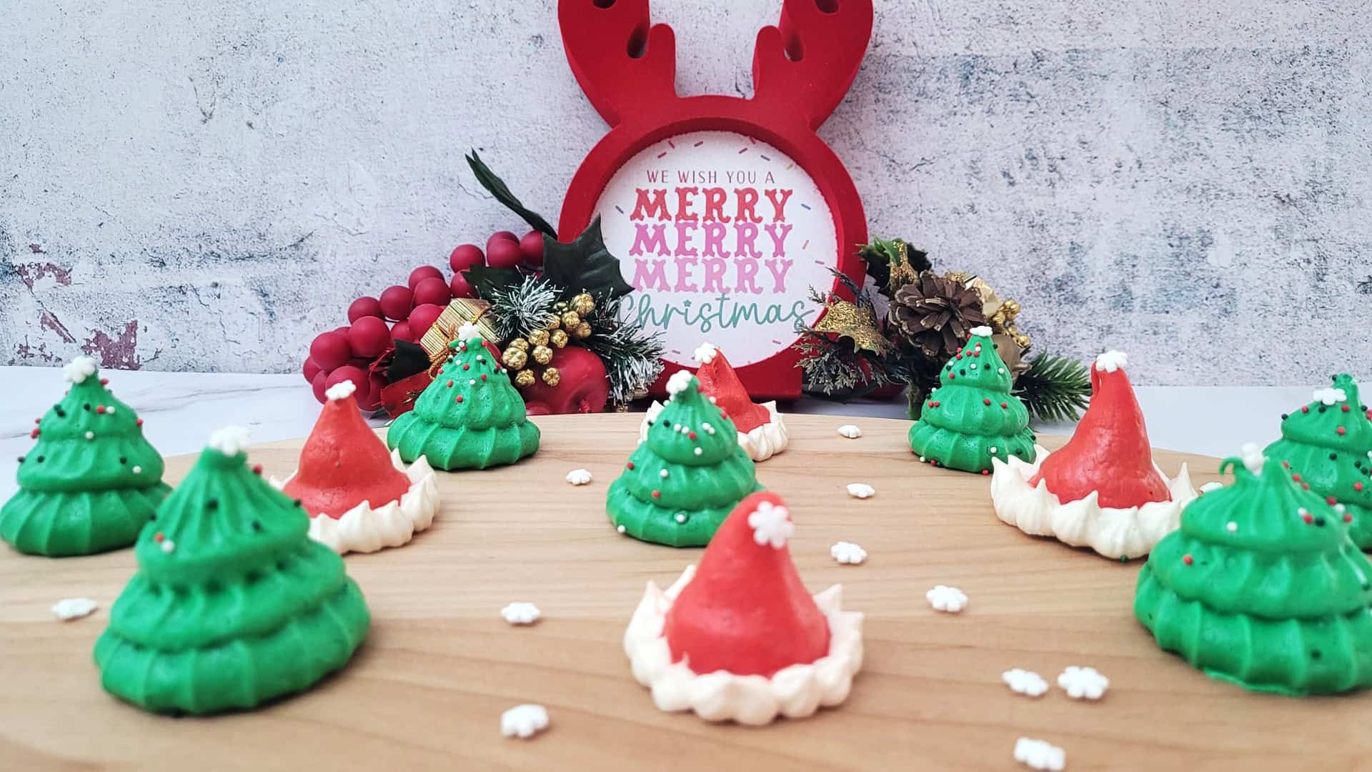 meringue cookies shaped like Christmas trees and Santa hats