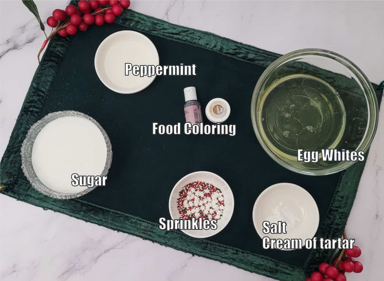 ingredients needed to make Christmas meringue cookies including egg whites, salt, cream of tartar, sugar, food coloring, sprinkles and peppermint extract