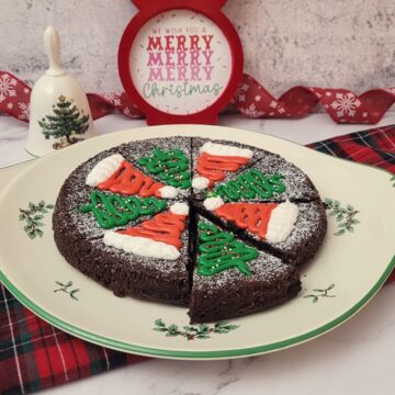 chocolate flourless Christmas cake decorated with holiday designs